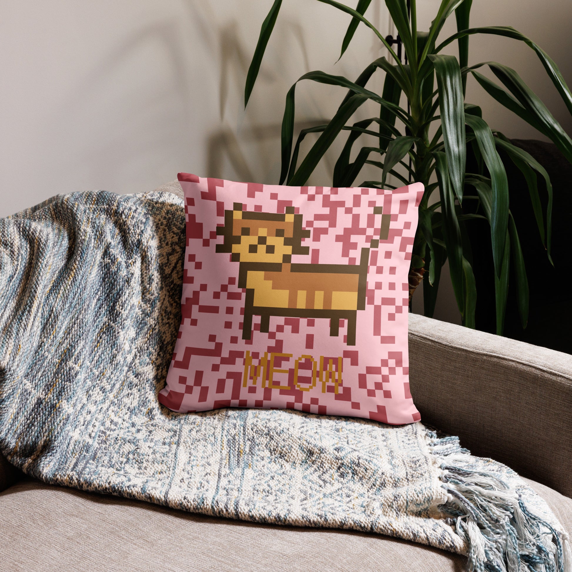 Pink pillow with a pixel photo of a cat and the text MEOW
