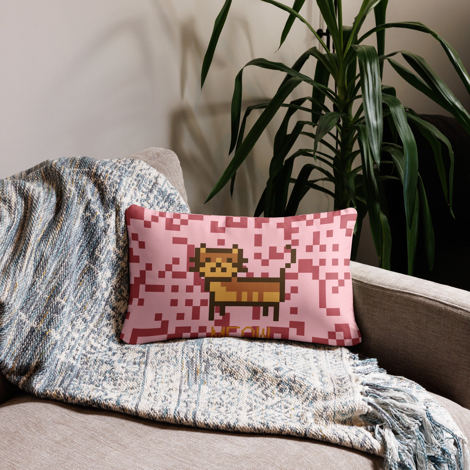 Pink pillow with a pixel photo of a cat and the text MEOW