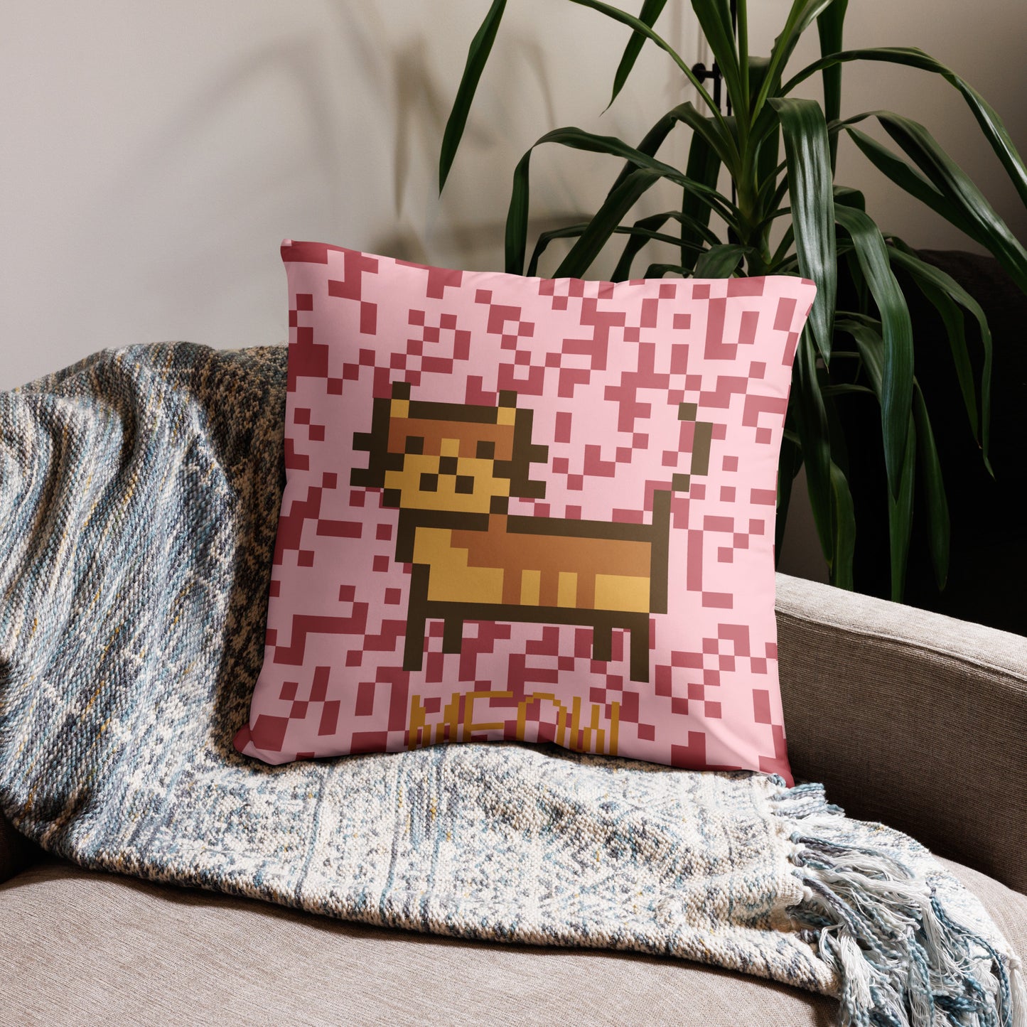 Pink pillow with a pixel photo of a cat and the text MEOW