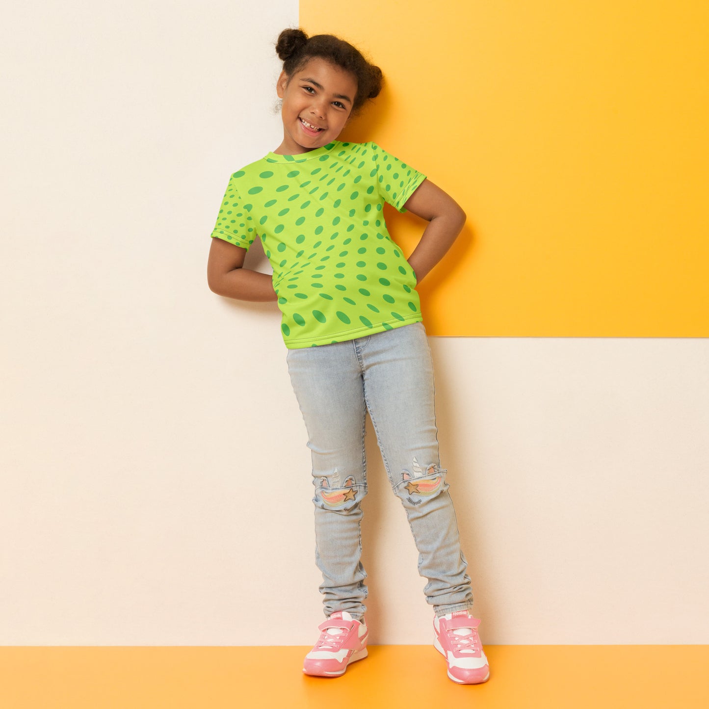 Kid with a green T-shirt with dark green dots