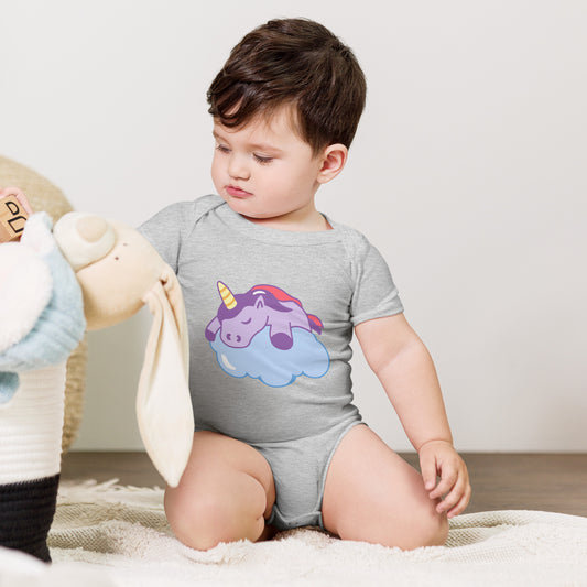 baby with a grey bodysuit with a print of a sleeping unicorn on a cloud
