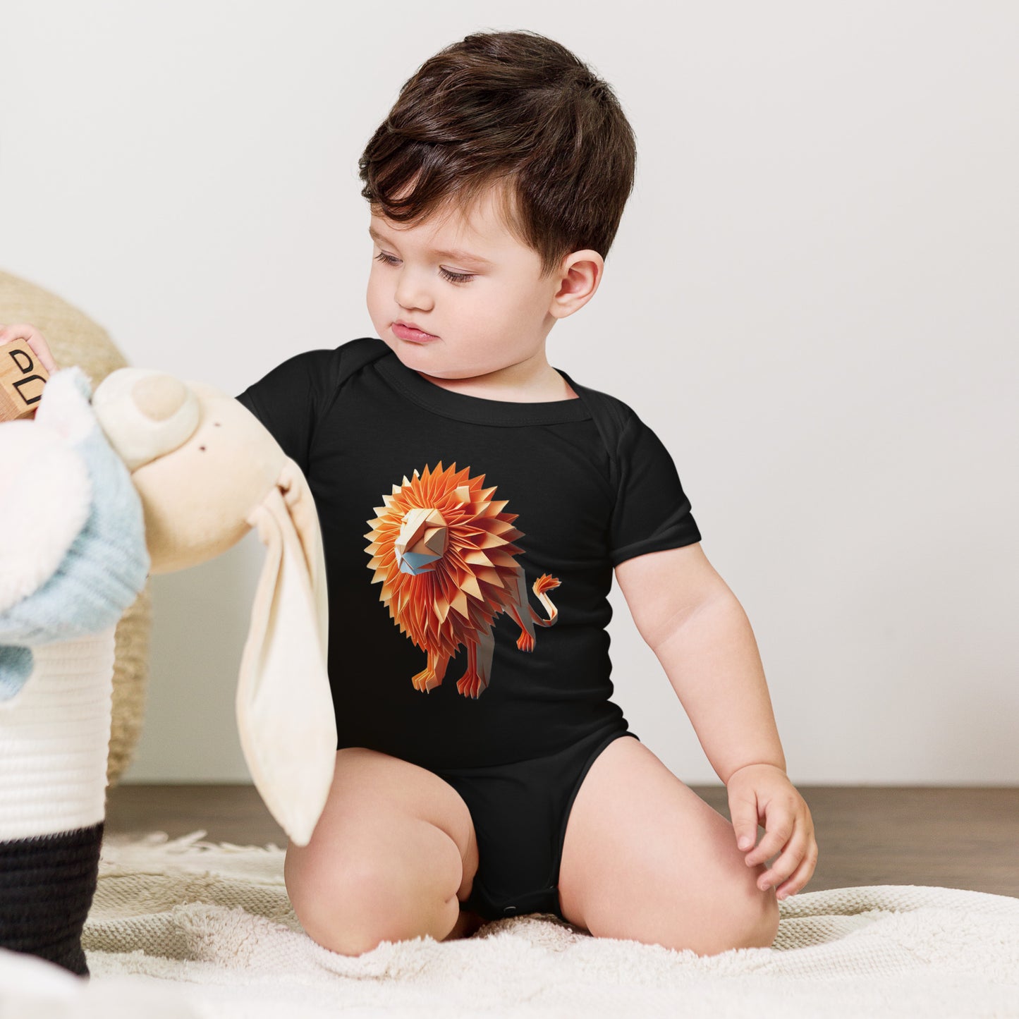 Baby with black bodysuit with print of a lion