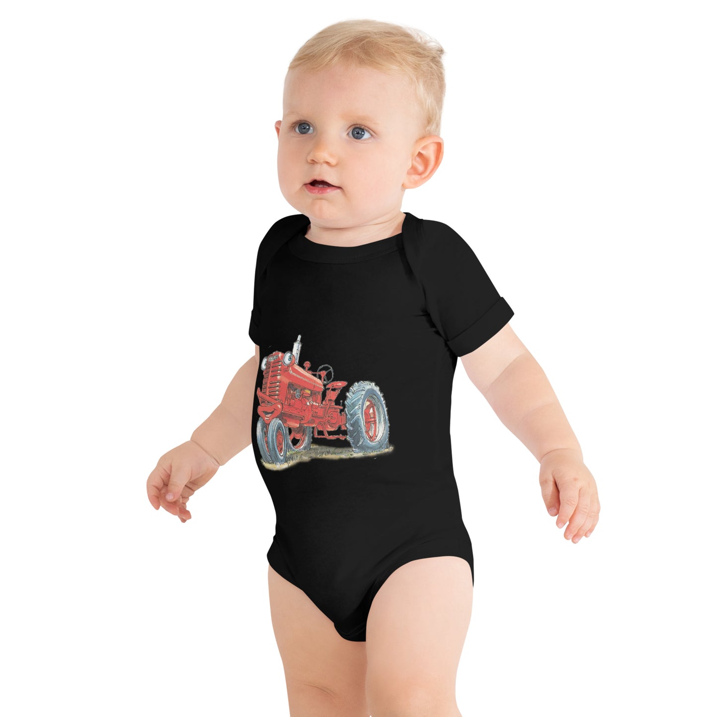 Baby with black body and a print of a red tractor