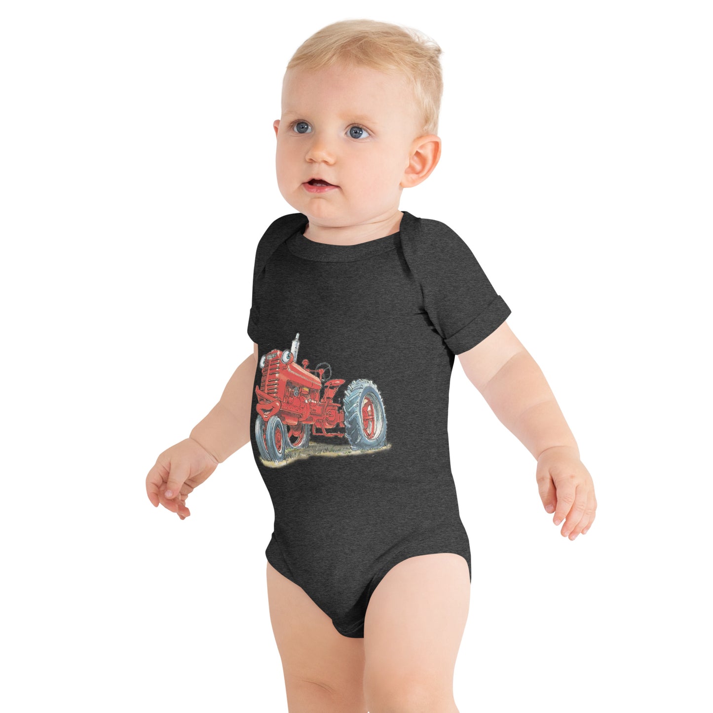 Baby with dark grey body and a print of a red tractor