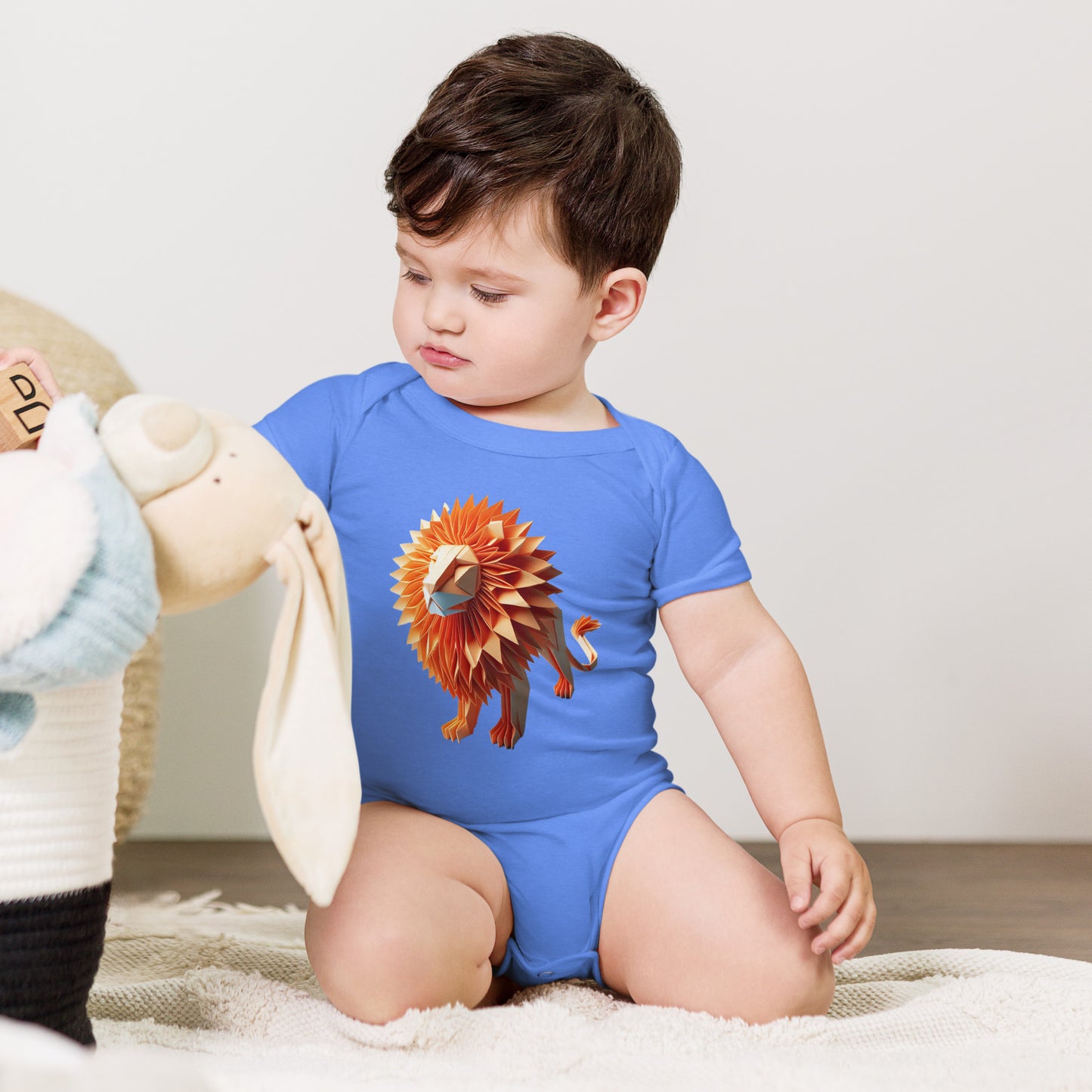 Baby with columbia blue bodysuit with print of a lion