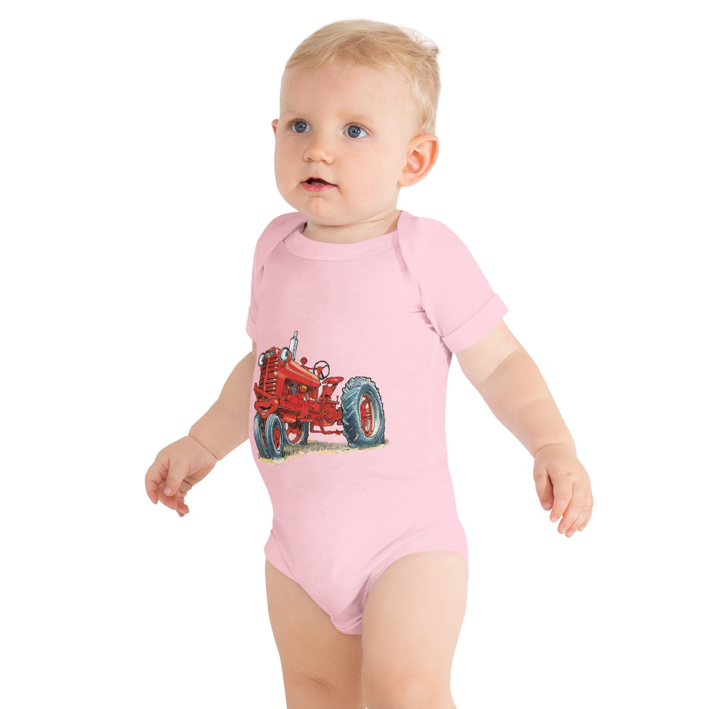 Baby with pink body and a print of a red tractor