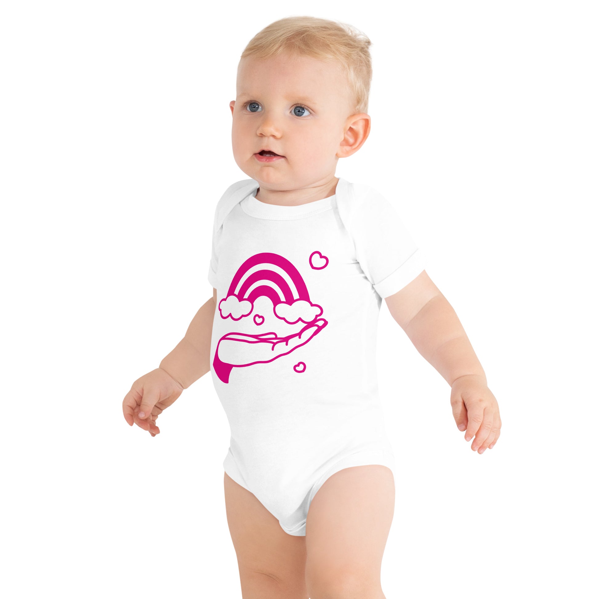 baby with white short sleeve one piece with print of pink hand holding a pink rainbow