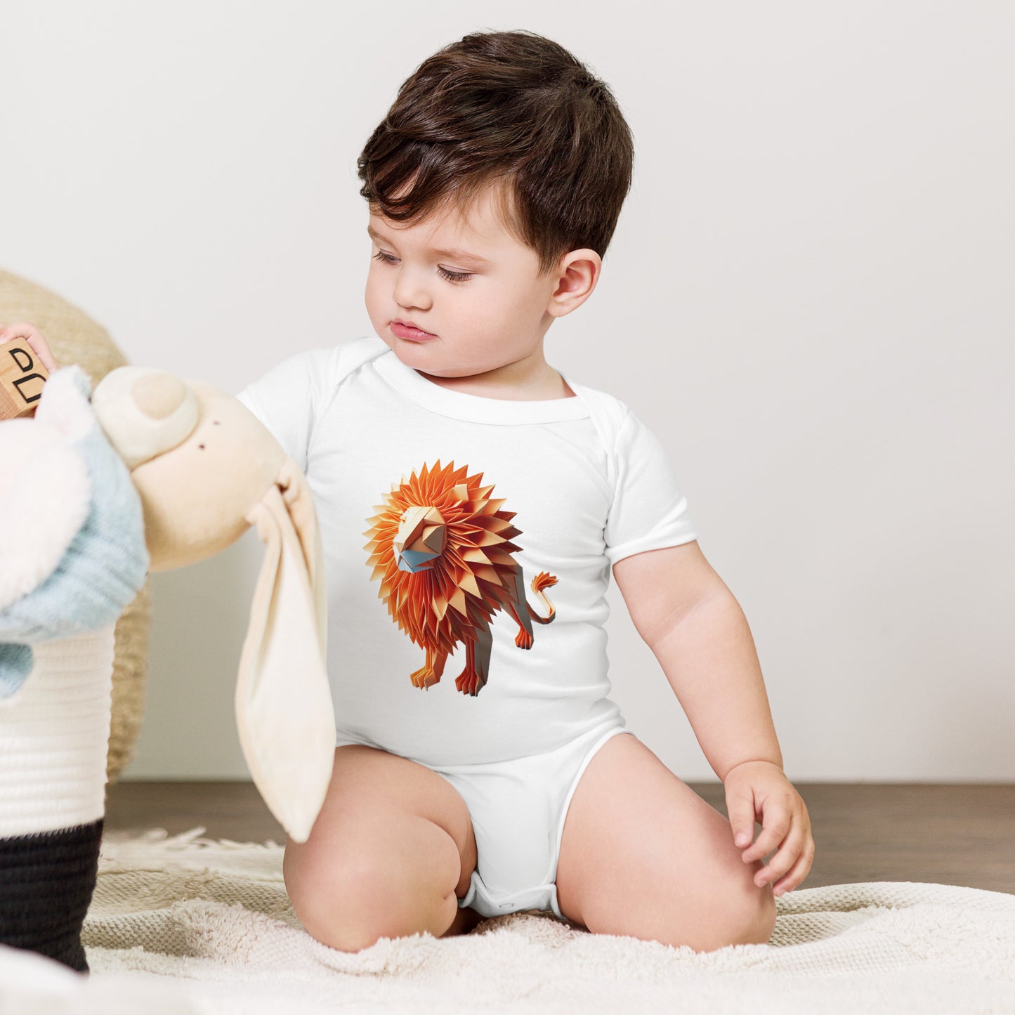 Baby with white bodysuit with print of a lion