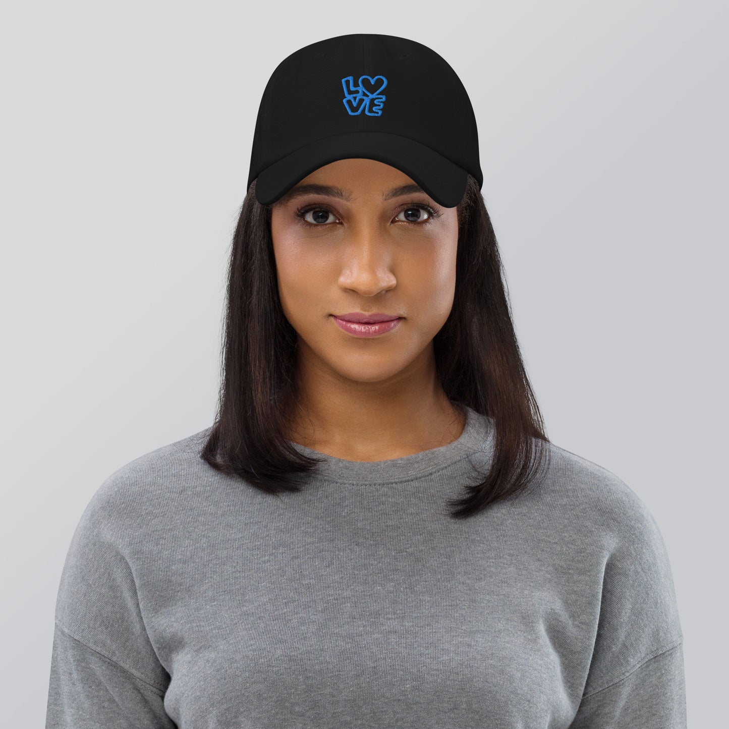 Women with black hat with the blue letters LOVE with the O in heart shape