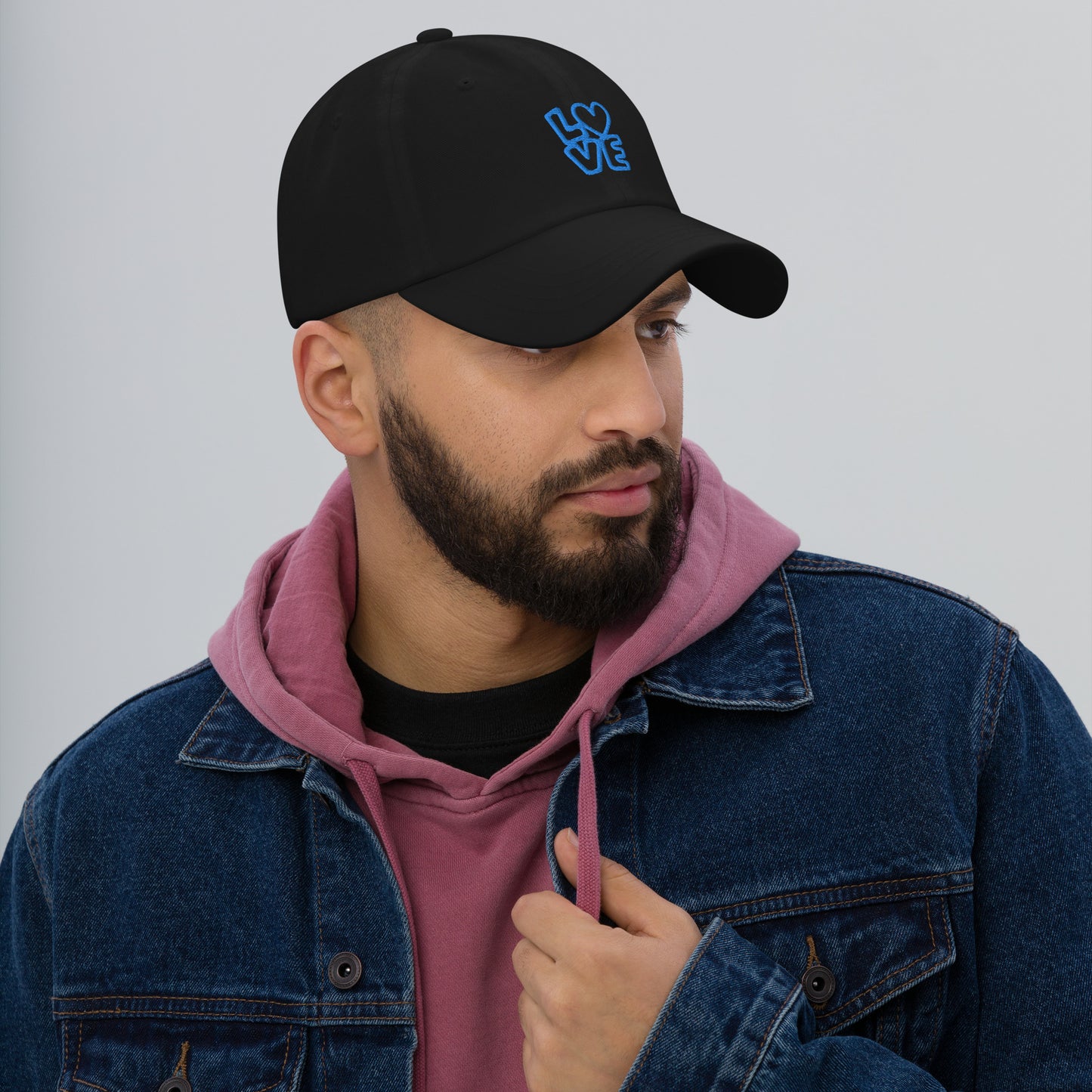 Men with black hat with the blue letters LOVE with the O in heart shape