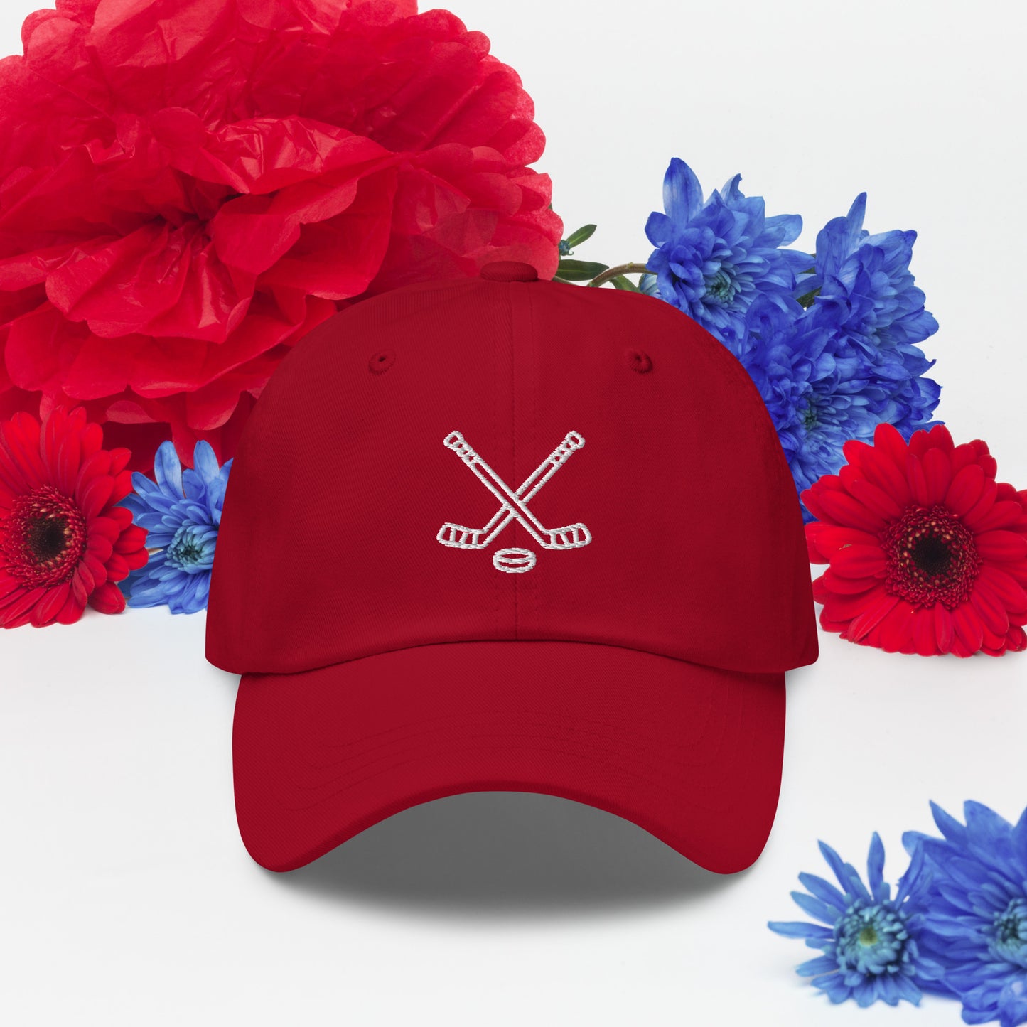 Cranberry hat with print of hockeysticks and puk