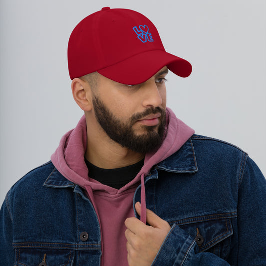 Men with cranberry hat with the blue letters LOVE with the O in heart shape