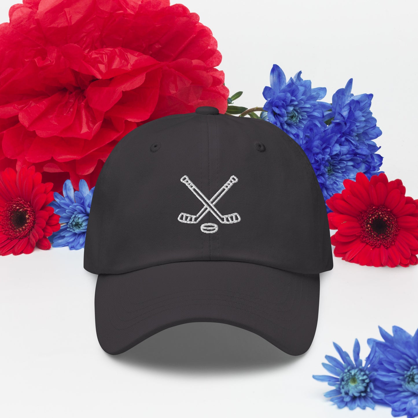 Dark grey hat with print of hockeysticks and puck