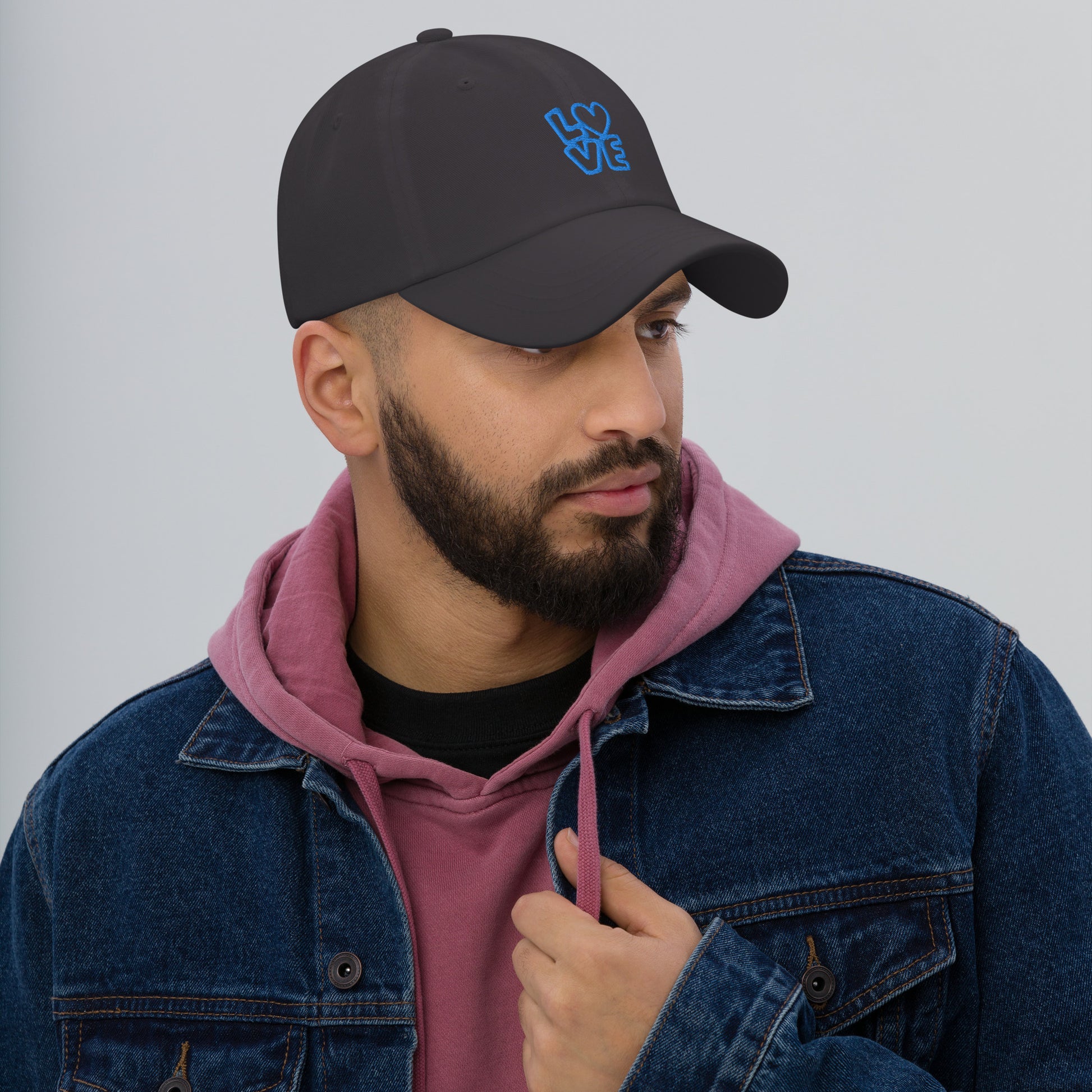 Men with dark grey hat with the blue letters LOVE with the O in heart shape