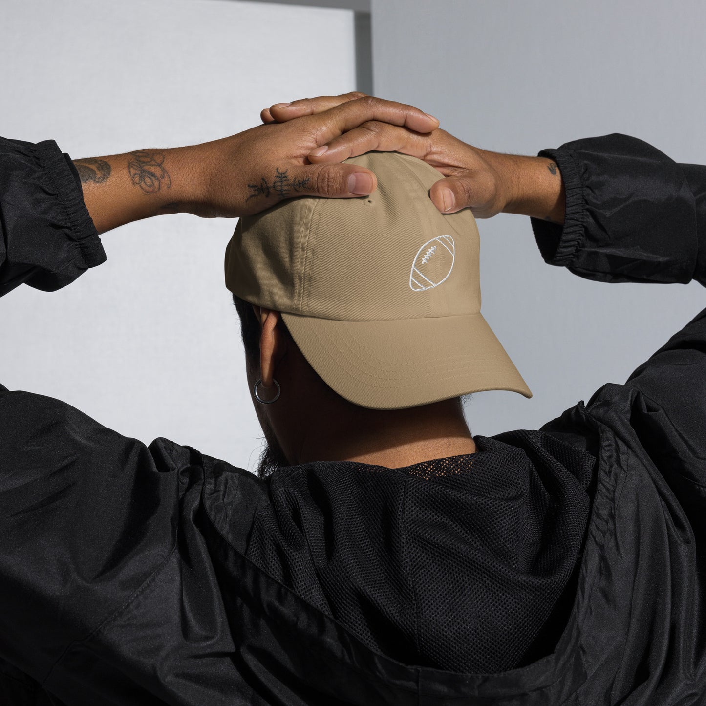 men with khaki baseball cap with football
