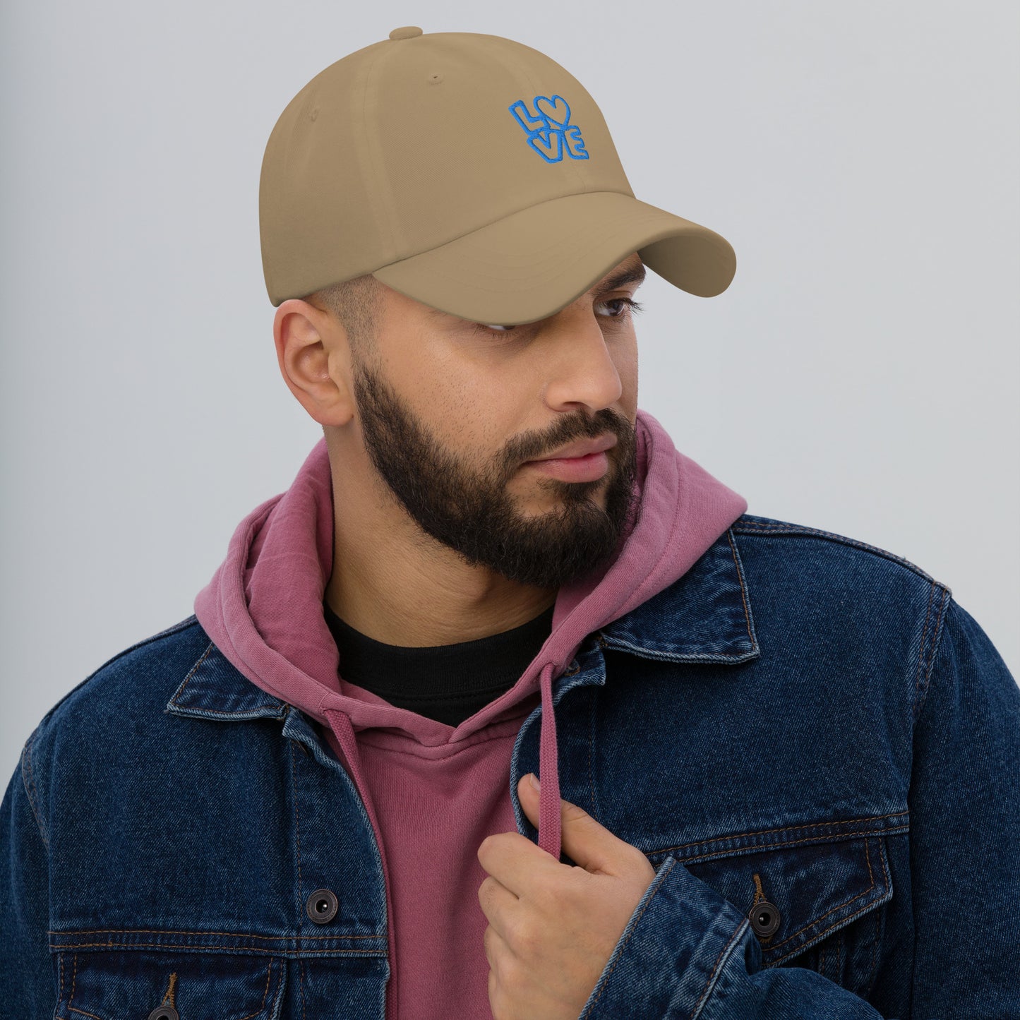 Men with khaki hat with the blue letters LOVE with the O in heart shape