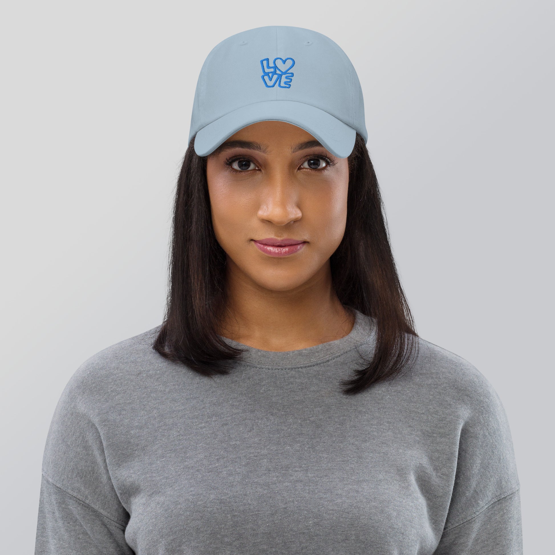 Women with light blue hat with the blue letters LOVE with the O in heart shape