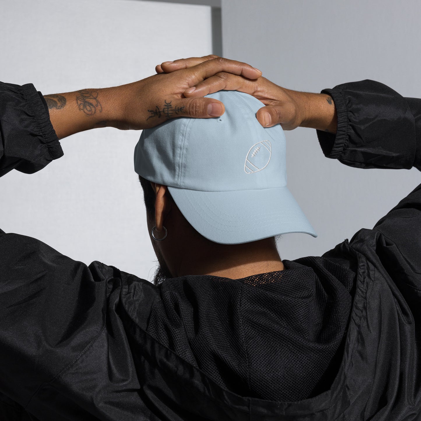 men with light blue baseball cap with football