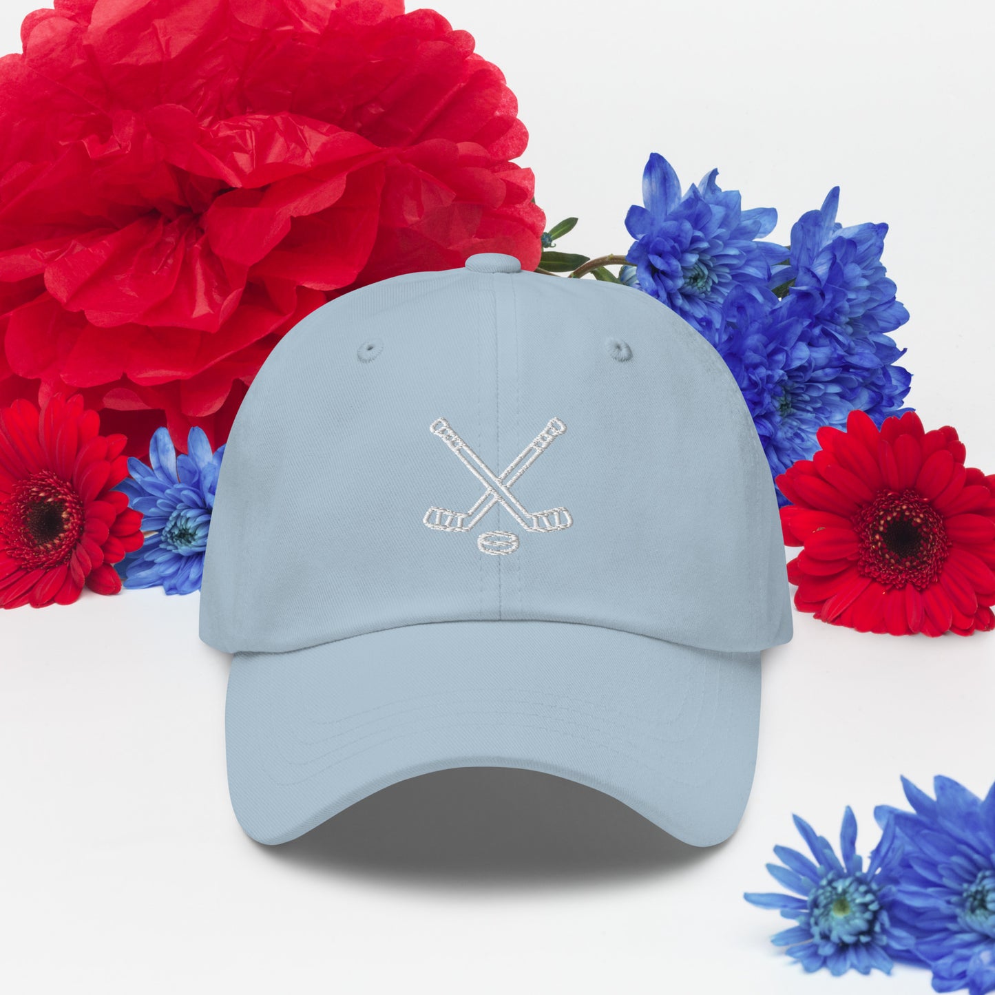 Light blue hat with print of hockeysticks and puck