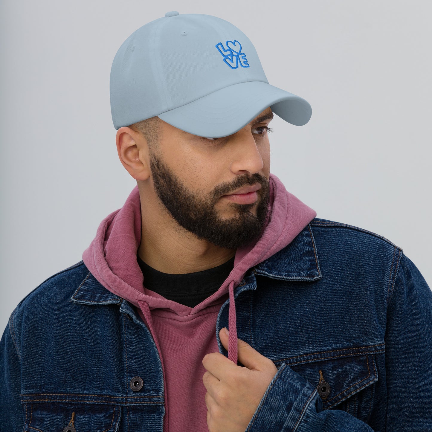 Men with light blue hat with the blue letters LOVE with the O in heart shape