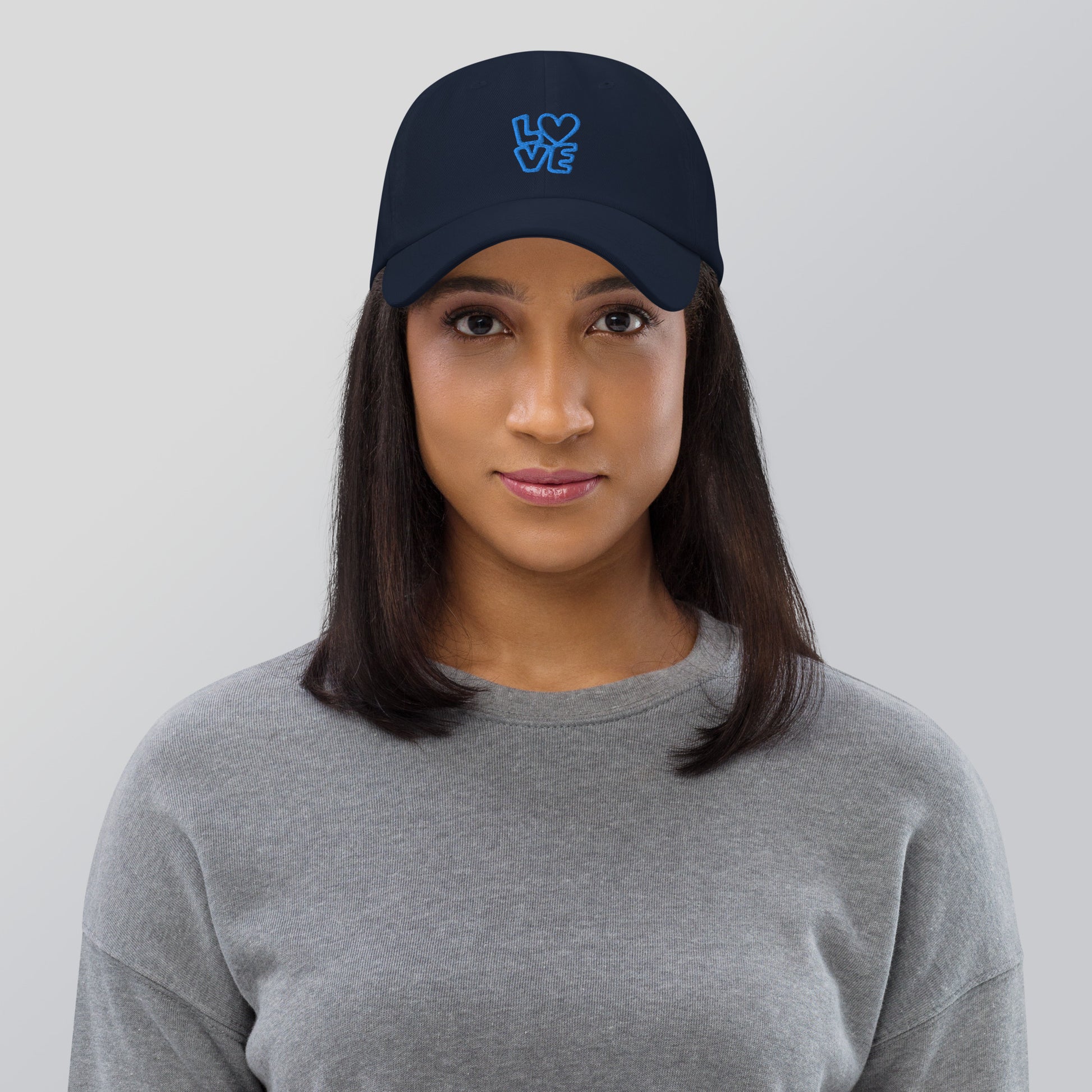 Women with Navy hat with the blue letters LOVE with the O in heart shape