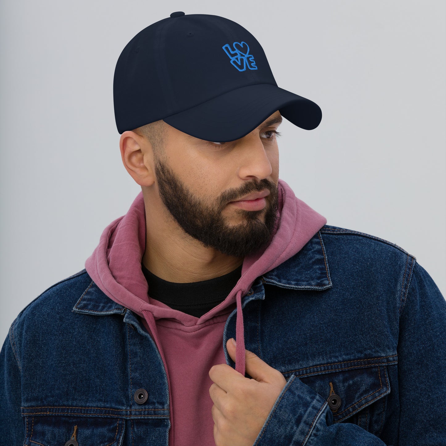 Men with navy hat with the blue letters LOVE with the O in heart shape