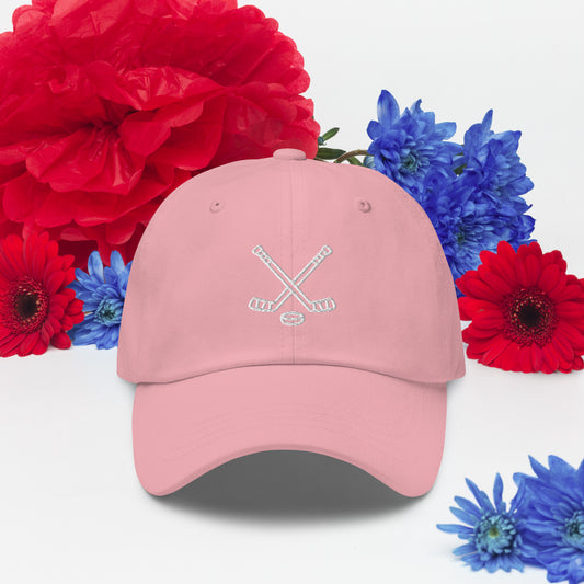 Pink hat with print of hockeysticks and puck