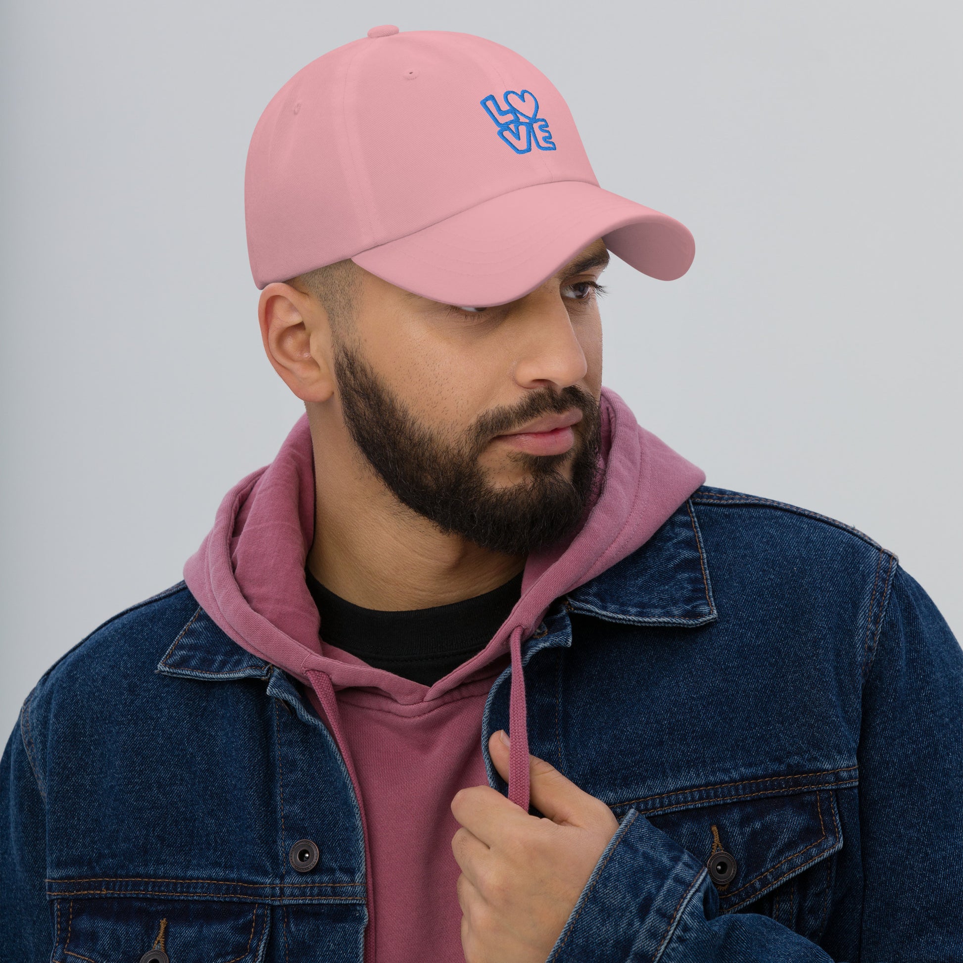 Men with pink hat with the blue letters LOVE with the O in heart shape
