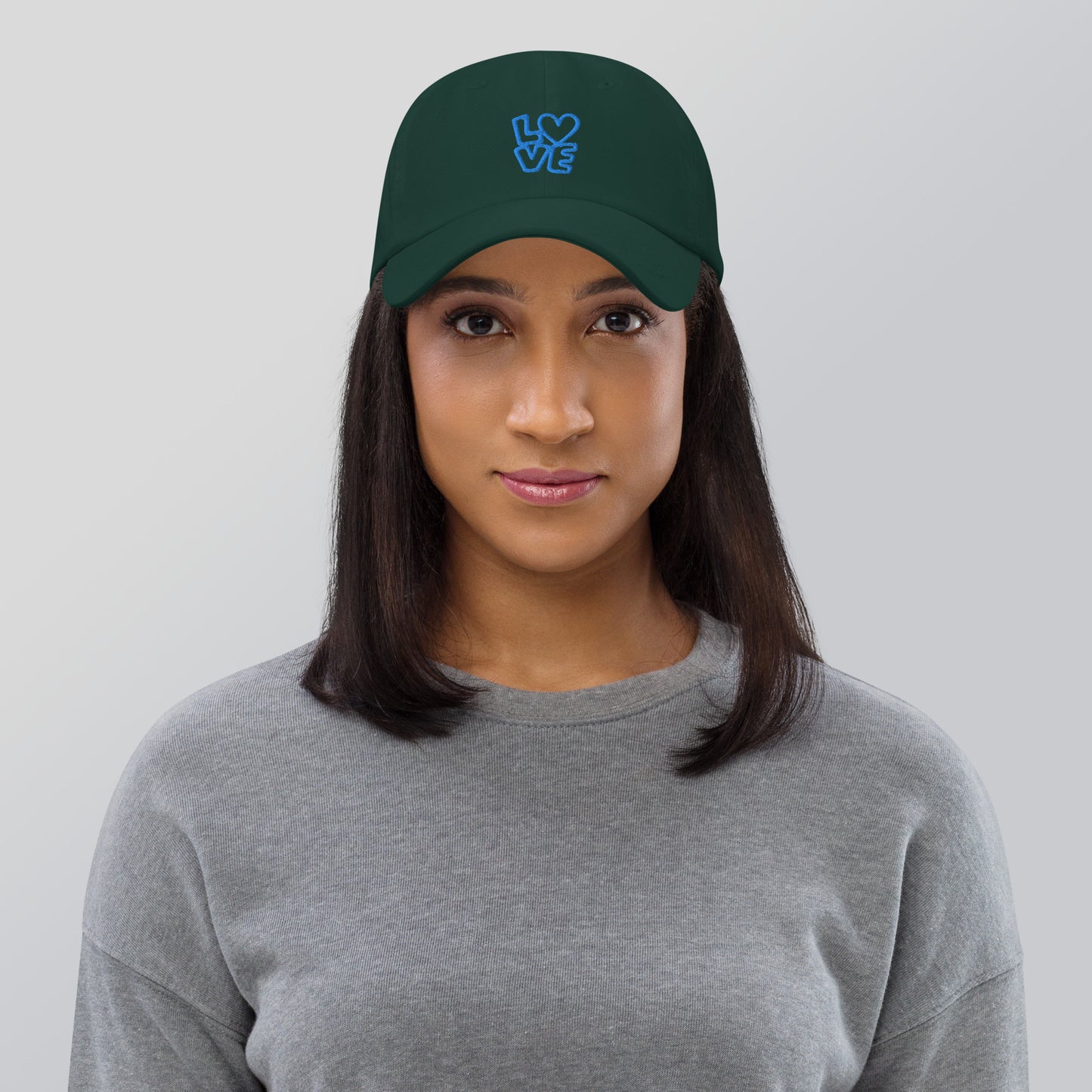 Women with spruce hat with the blue letters LOVE with the O in heart shape