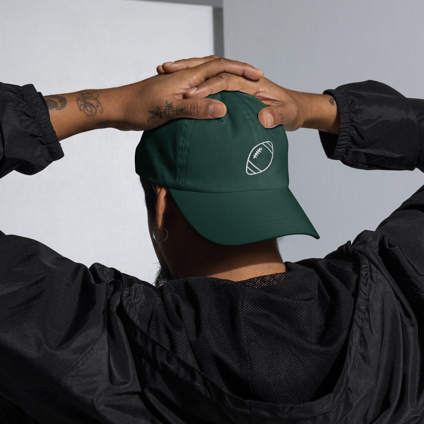 men with green baseball cap with football