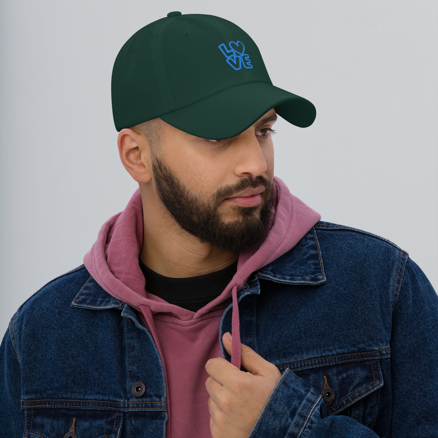 Men with green hat with the blue letters LOVE with the O in heart shape