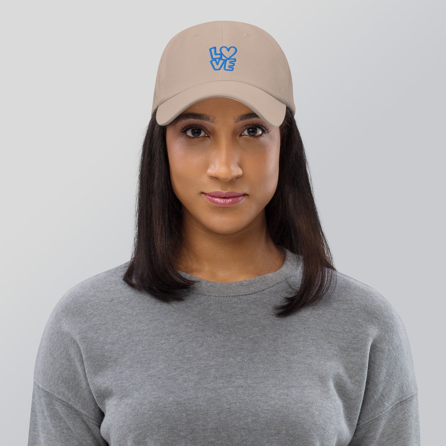 Women with stone hat with the blue letters LOVE with the O in heart shape