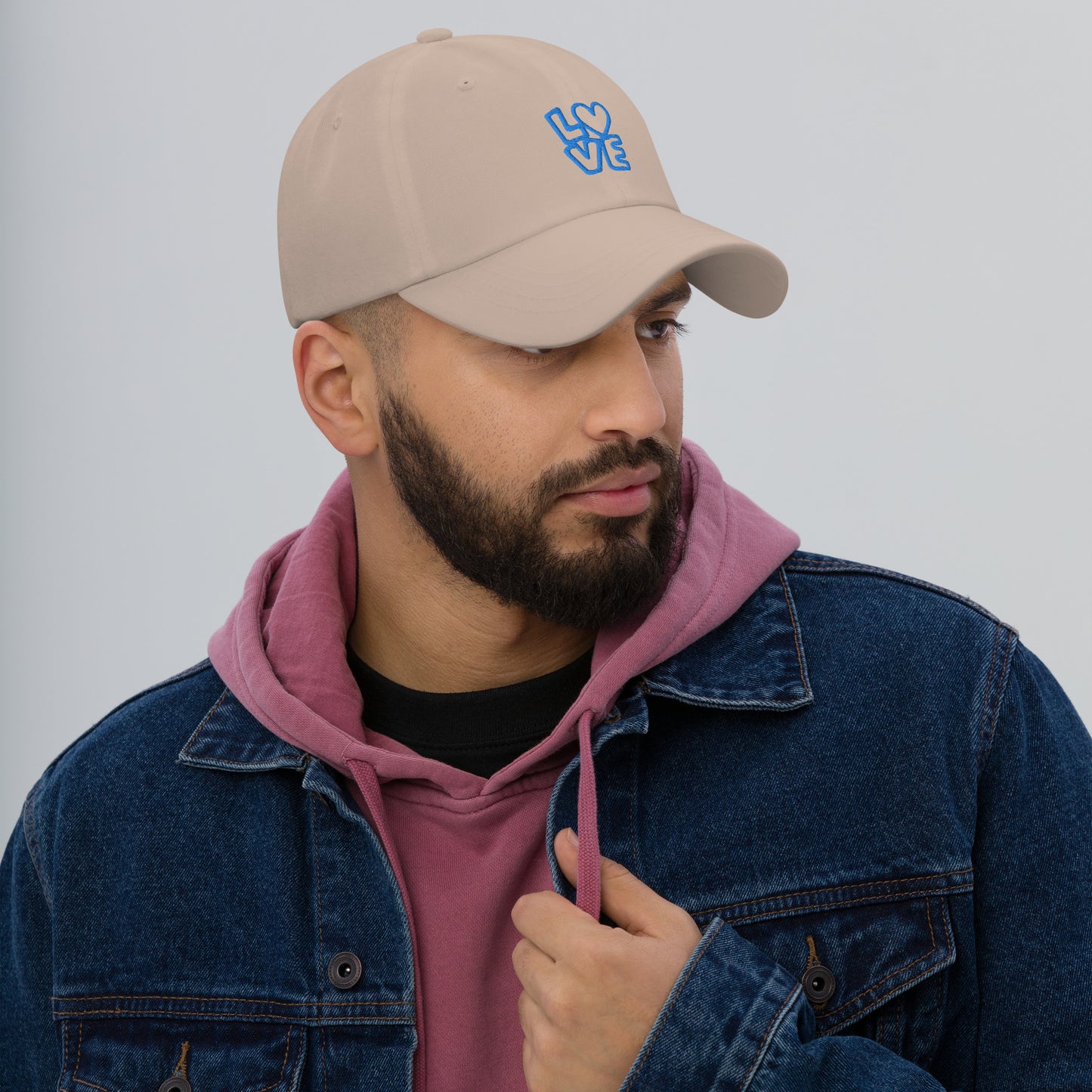 Men with stone hat with the blue letters LOVE with the O in heart shape