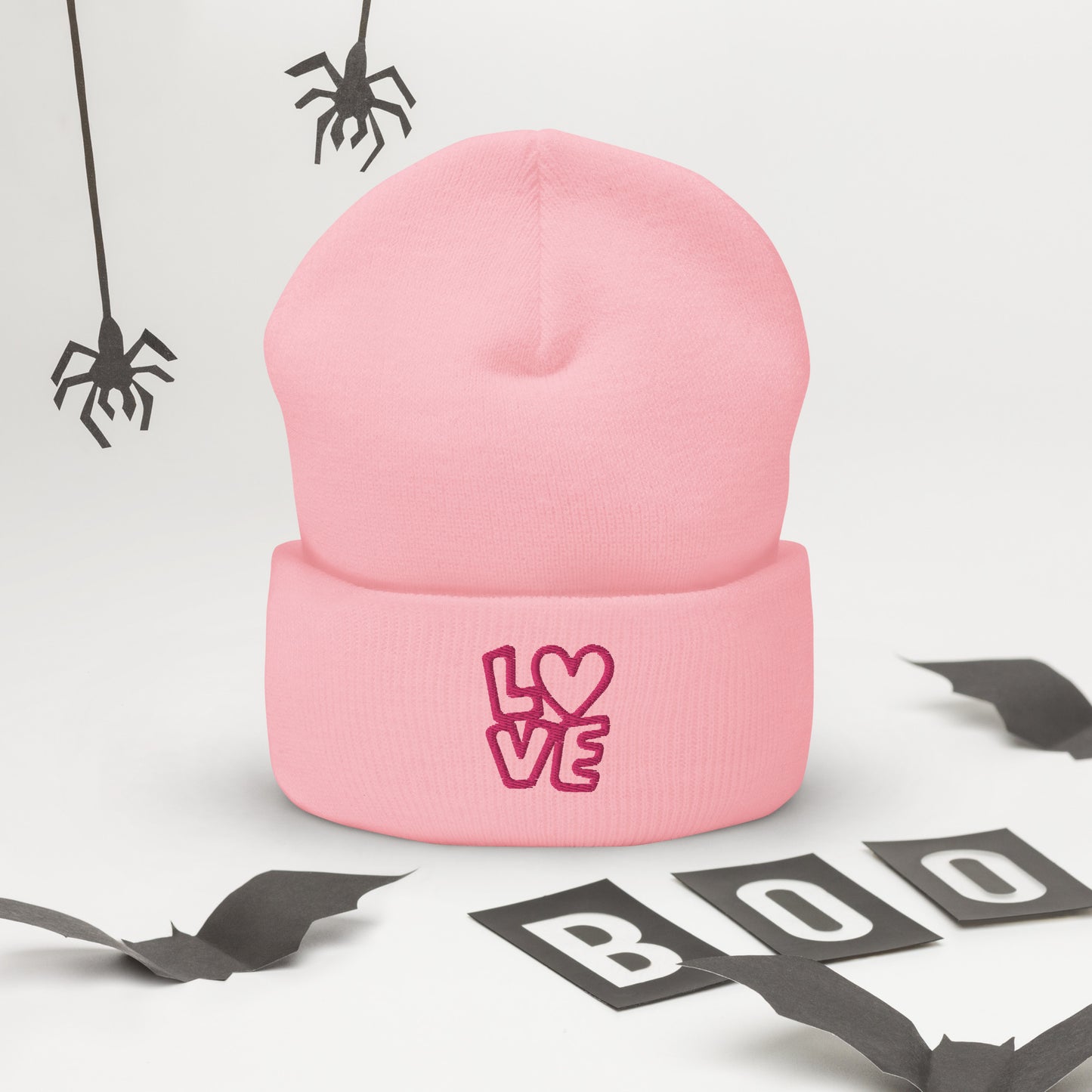 Pink beanie with the pink letters LOVE with the O in heart shape