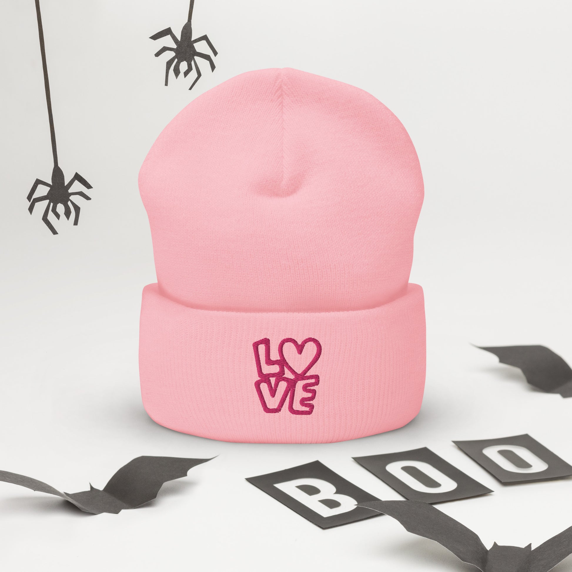 Pink beanie with the pink letters LOVE with the O in heart shape