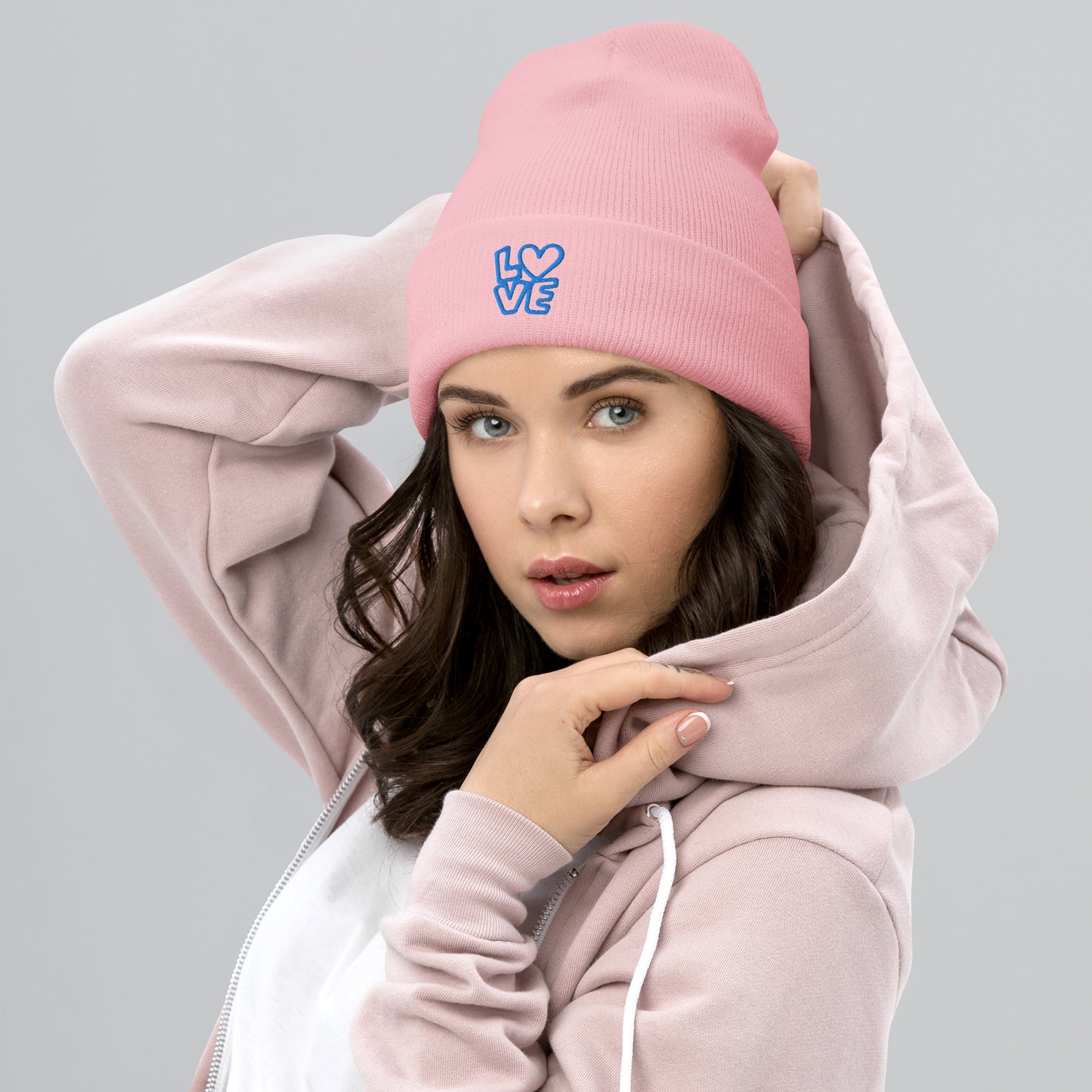 Women with pink beanie with the blue letters LOVE with the O in heart shape