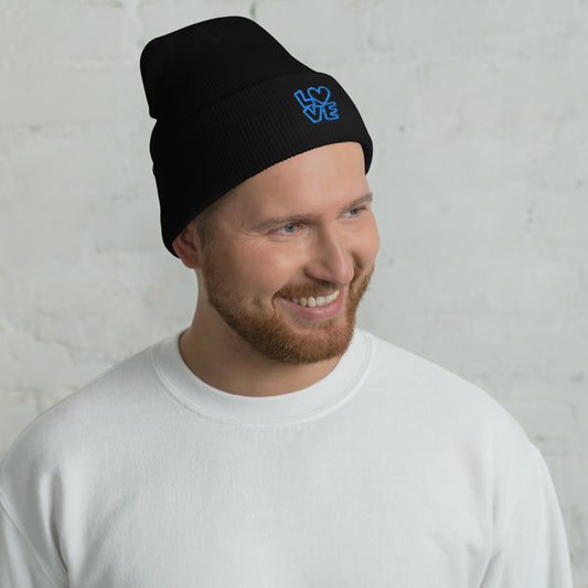 Men with black beanie with the blue letters LOVE with the O in heart shape