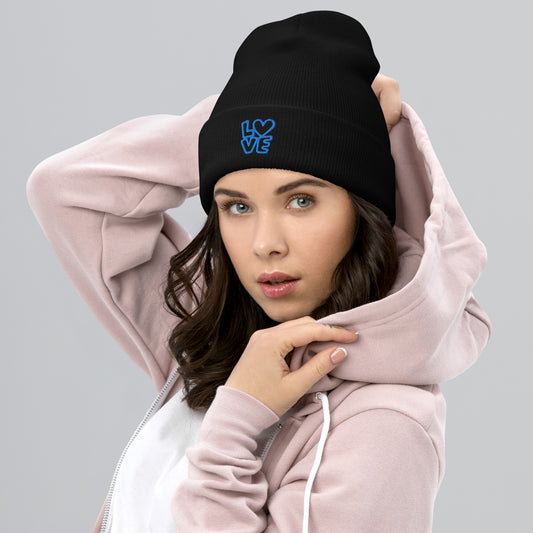 Women with black beanie with the blue letters LOVE with the O in heart shape