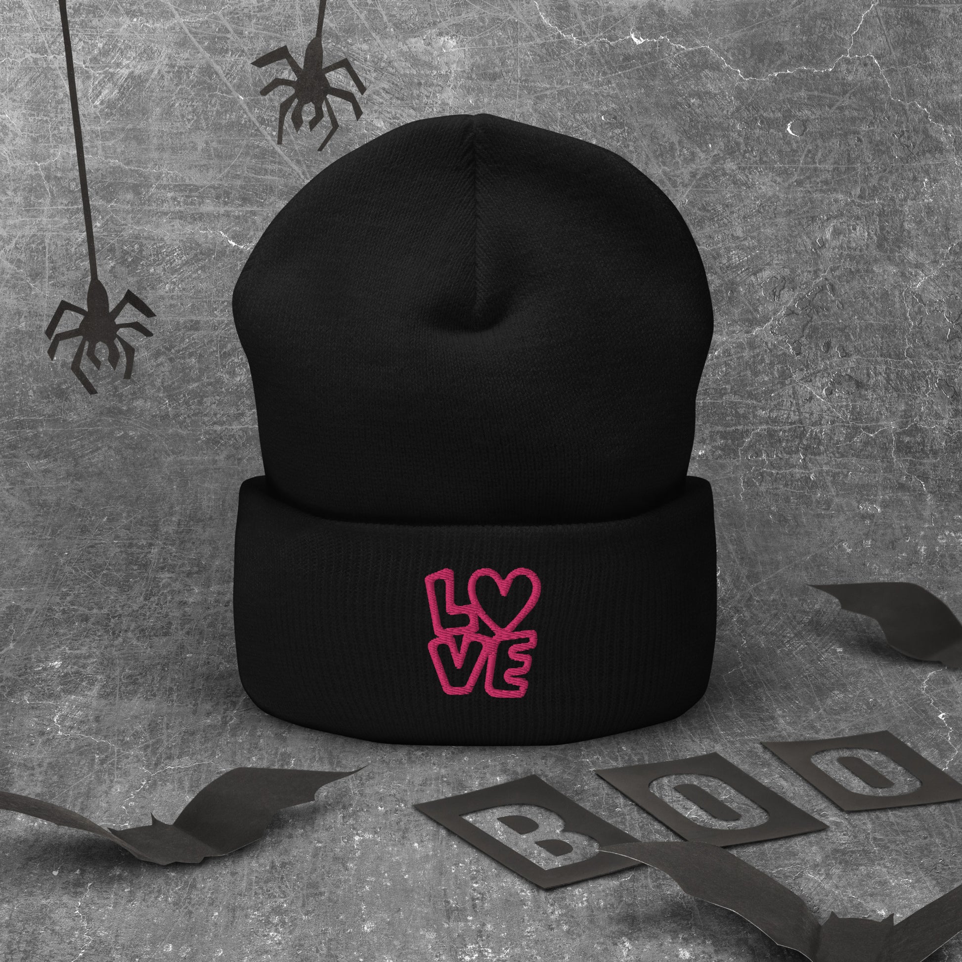Black beanie with the pink letters LOVE with the O in heart shape