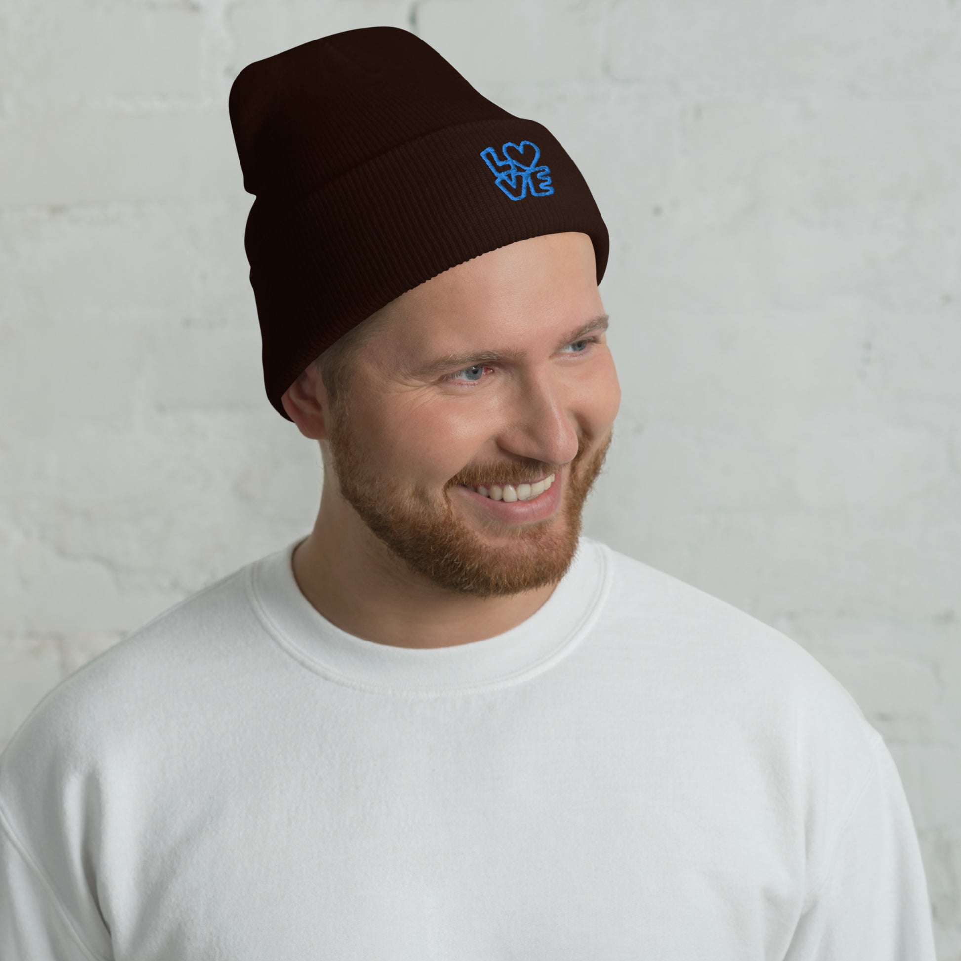 Men with brown beanie with the blue letters LOVE with the O in heart shape