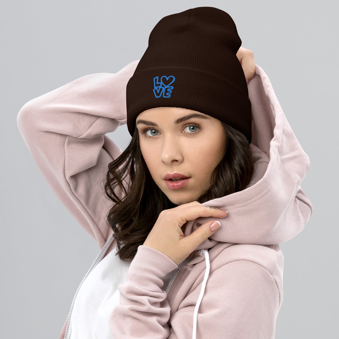 Women with brown beanie with the blue letters LOVE with the O in heart shape