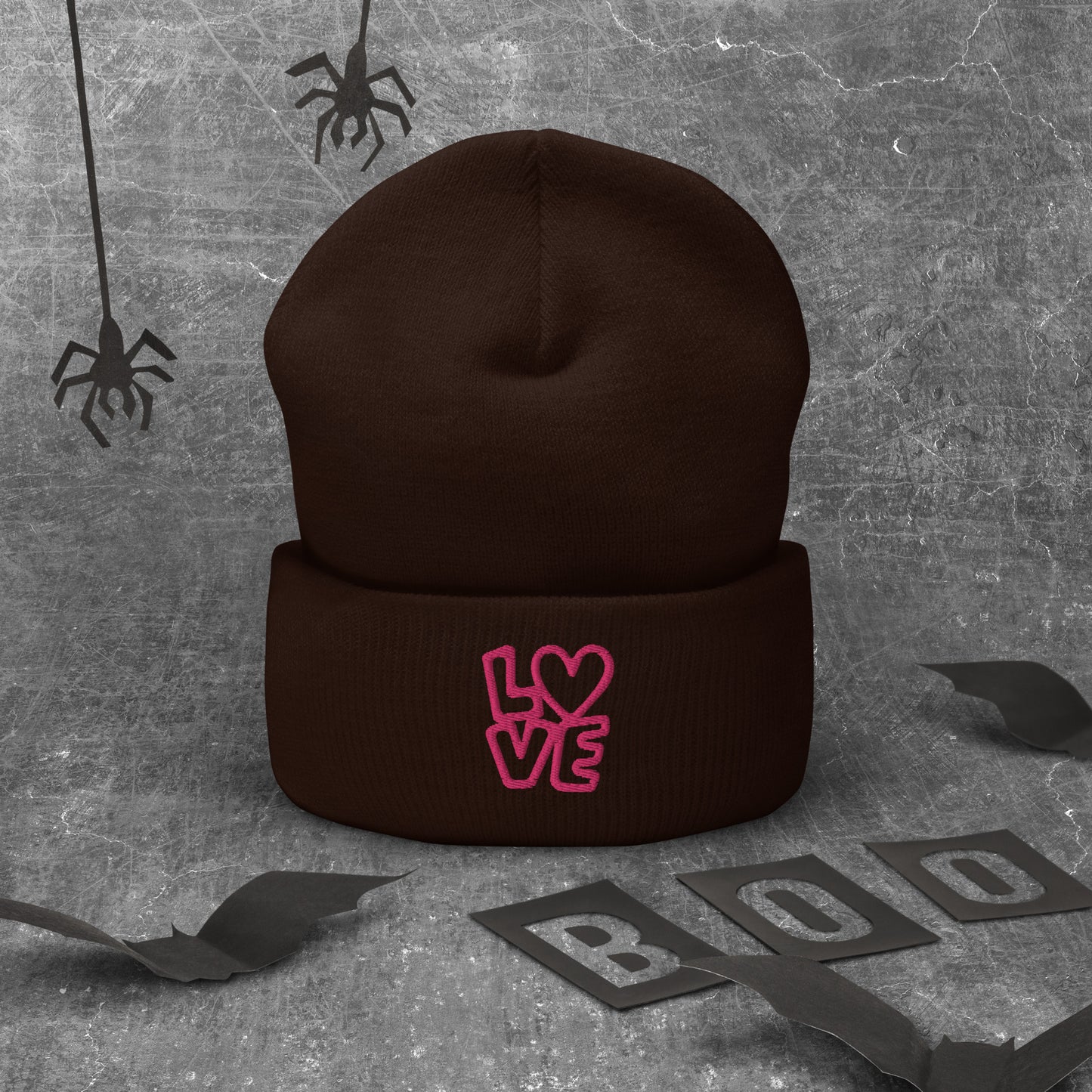 Brown beanie with the pink letters LOVE with the O in heart shape