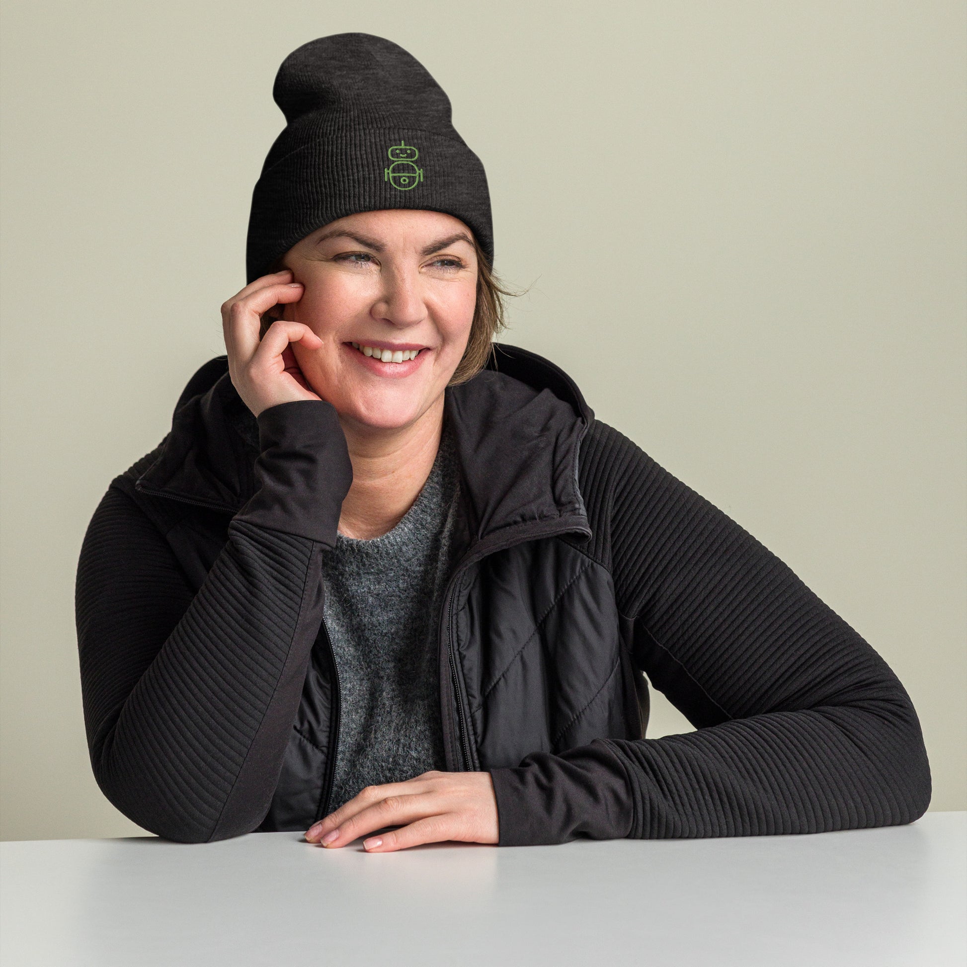 Women with dark grey beanie and Android logo in green