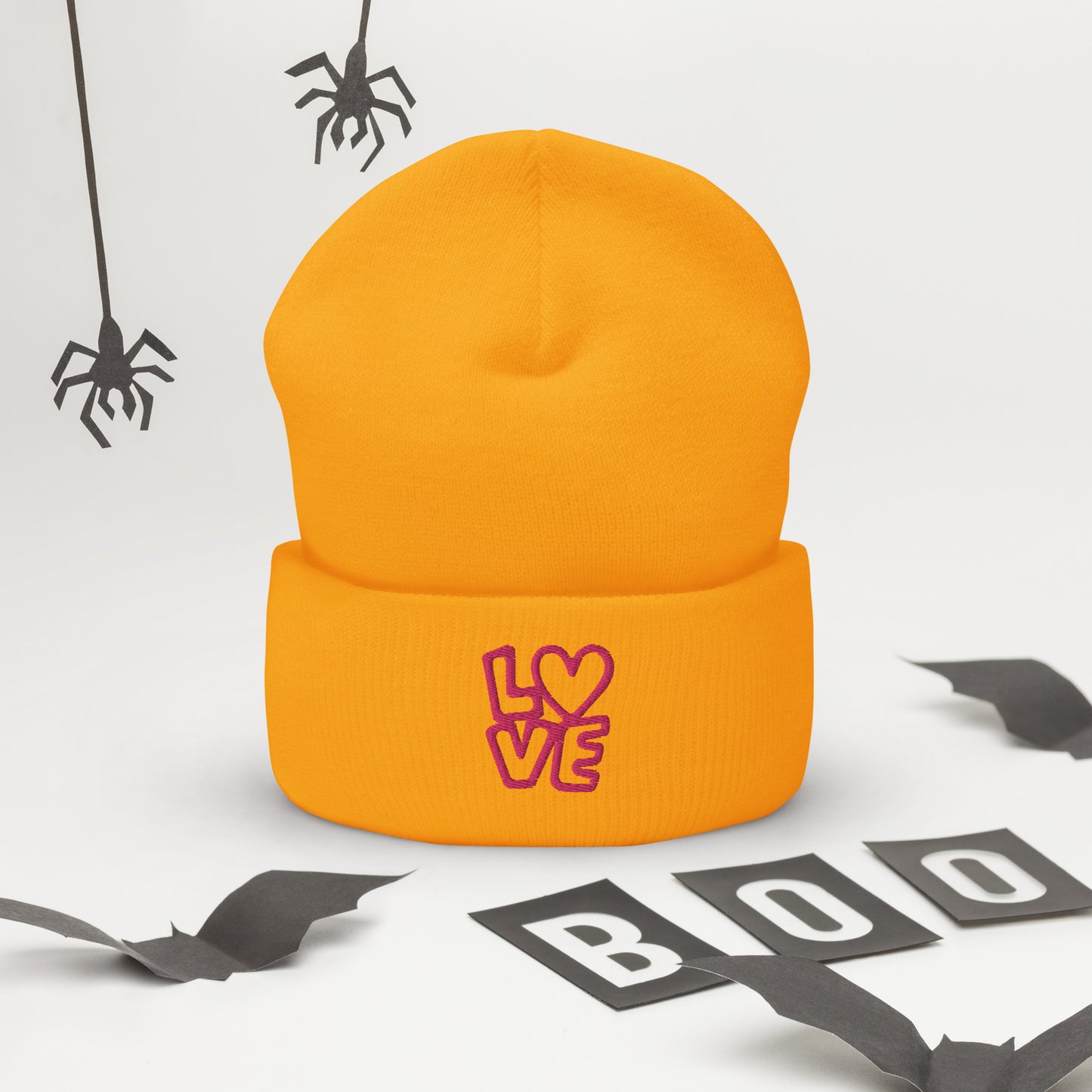Gold beanie with the pink letters LOVE with the O in heart shape
