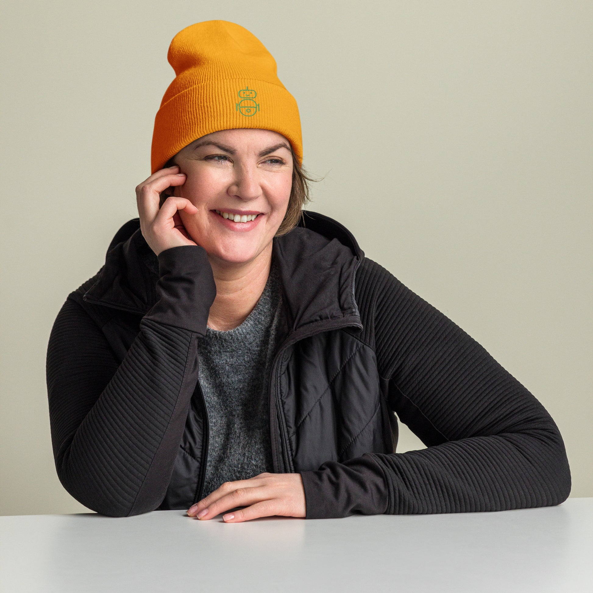 Women with gold beanie and Android logo in green