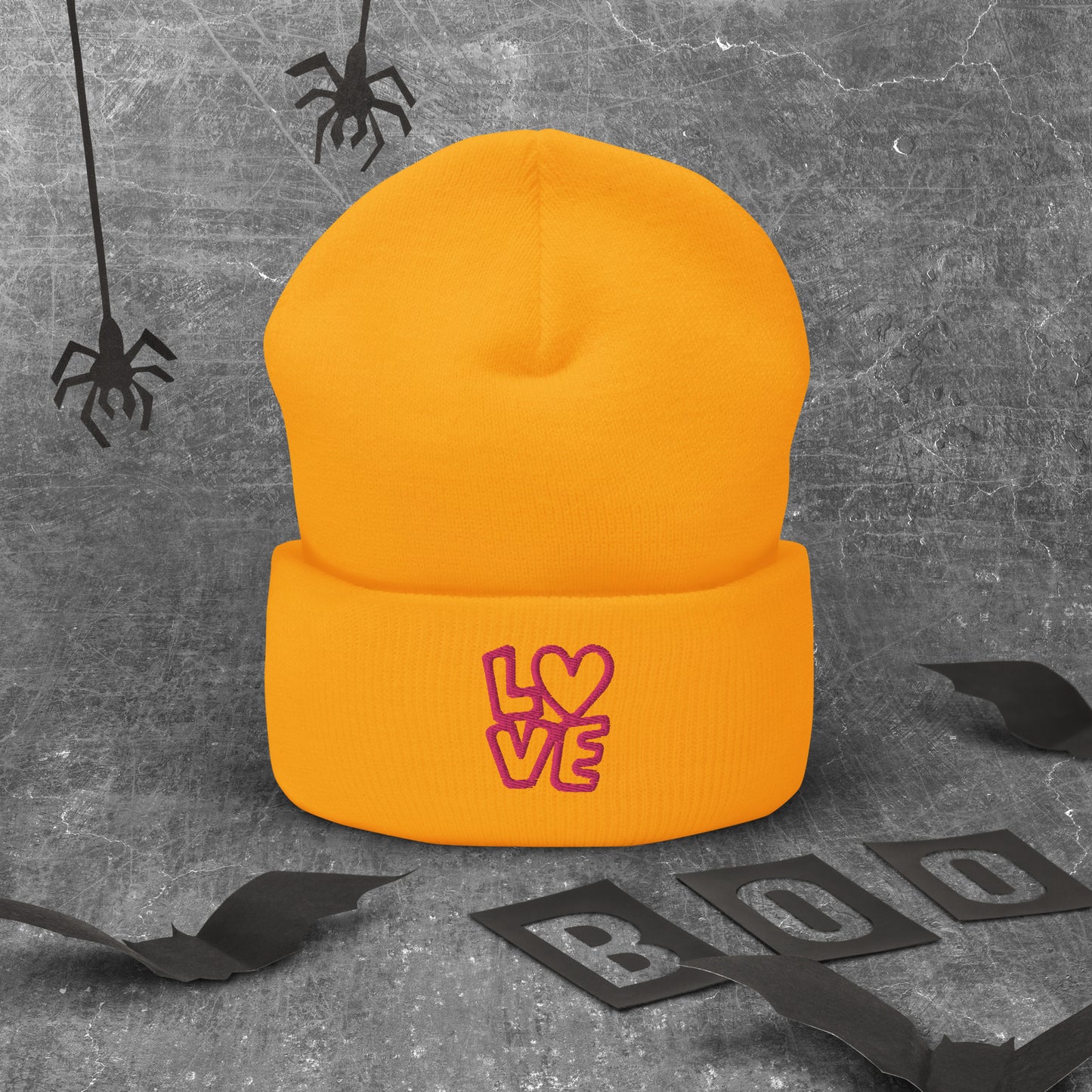Gold beanie with the pink letters LOVE with the O in heart shape