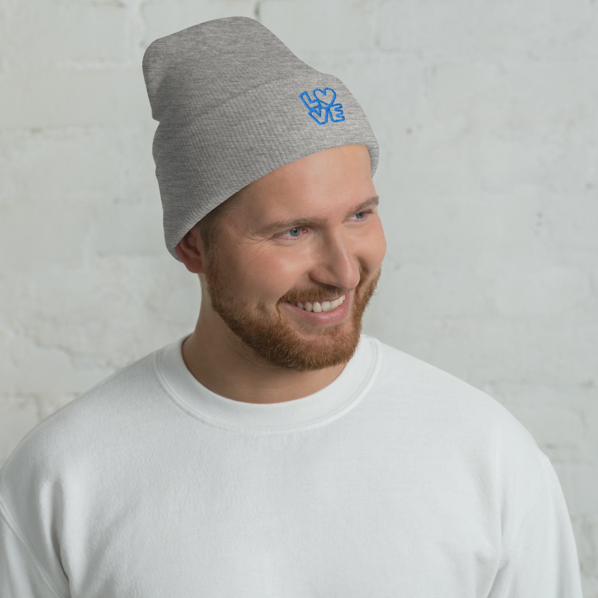 Men with grey beanie with the blue letters LOVE with the O in heart shape