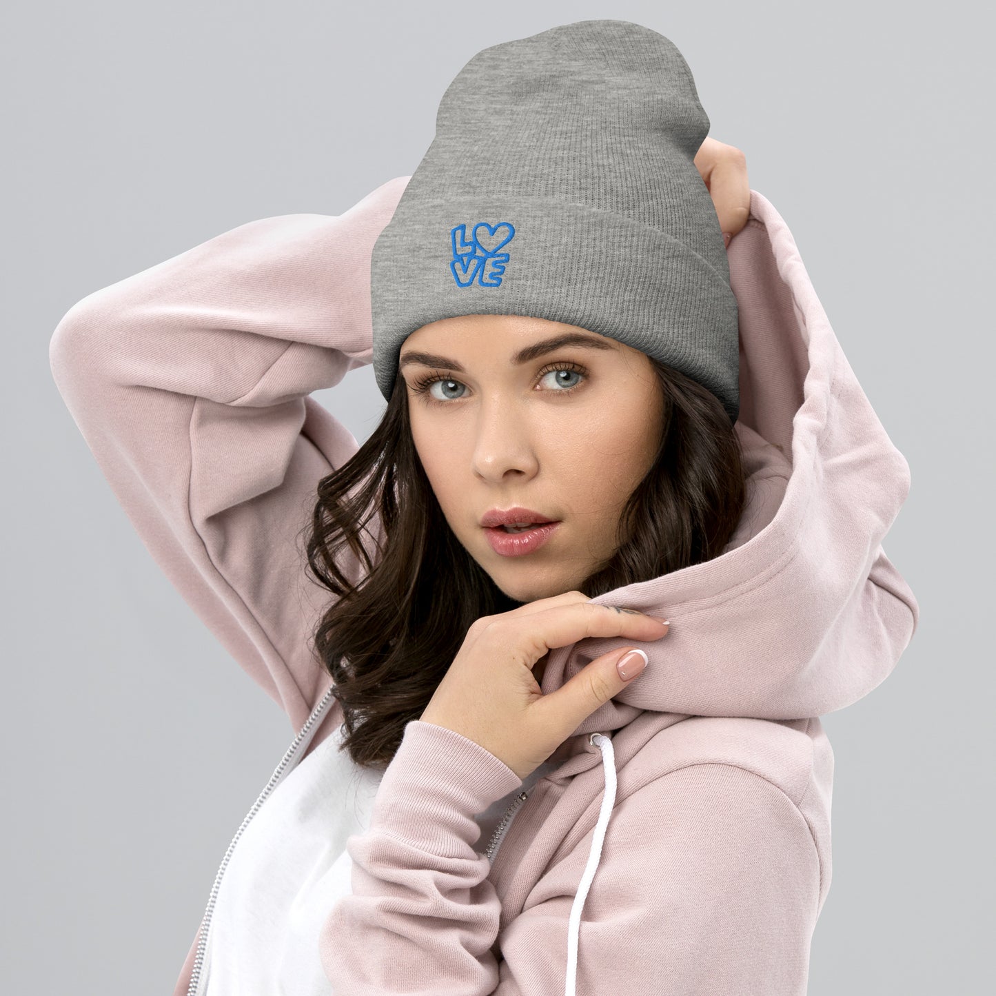 Women with grey beanie with the blue letters LOVE with the O in heart shape