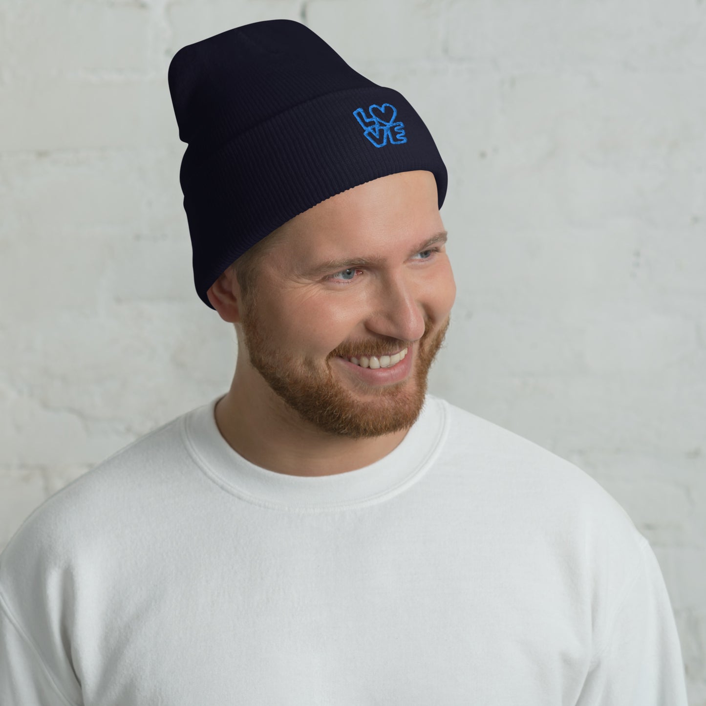 Men with navy beanie with the blue letters LOVE with the O in heart shape