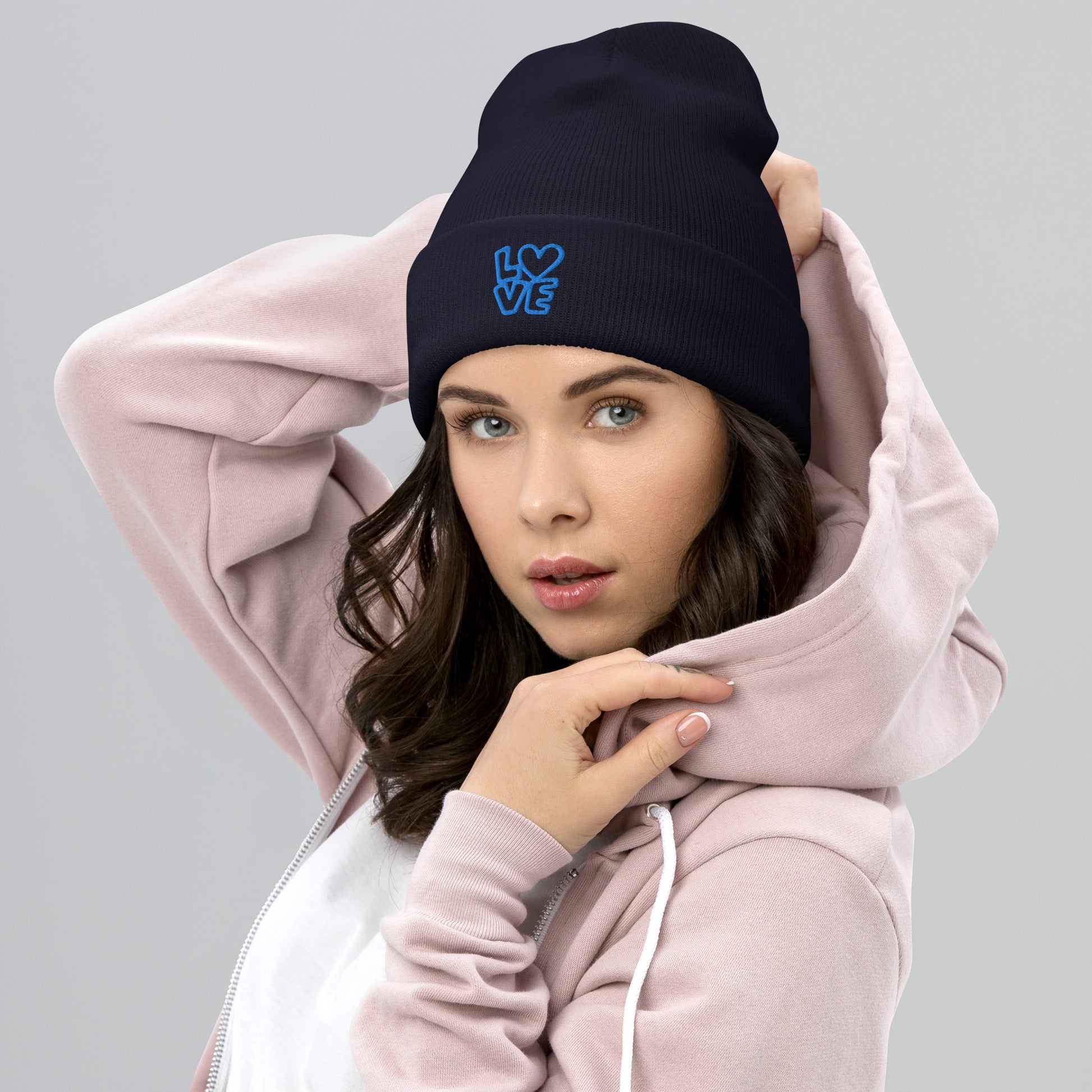 Women with navy beanie with the blue letters LOVE with the O in heart shape